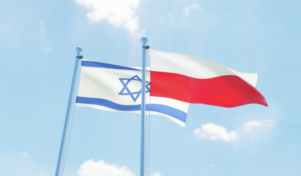Poland and Israel, two flags waving against blue sky