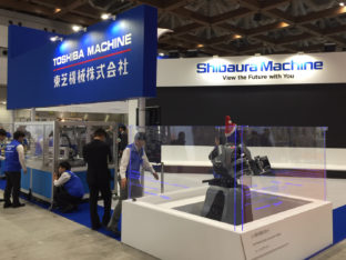 Stoisko na targach z robotem humanoidalnym Shibaura (Toshiba) Machine w czapce św. Mikołaja.