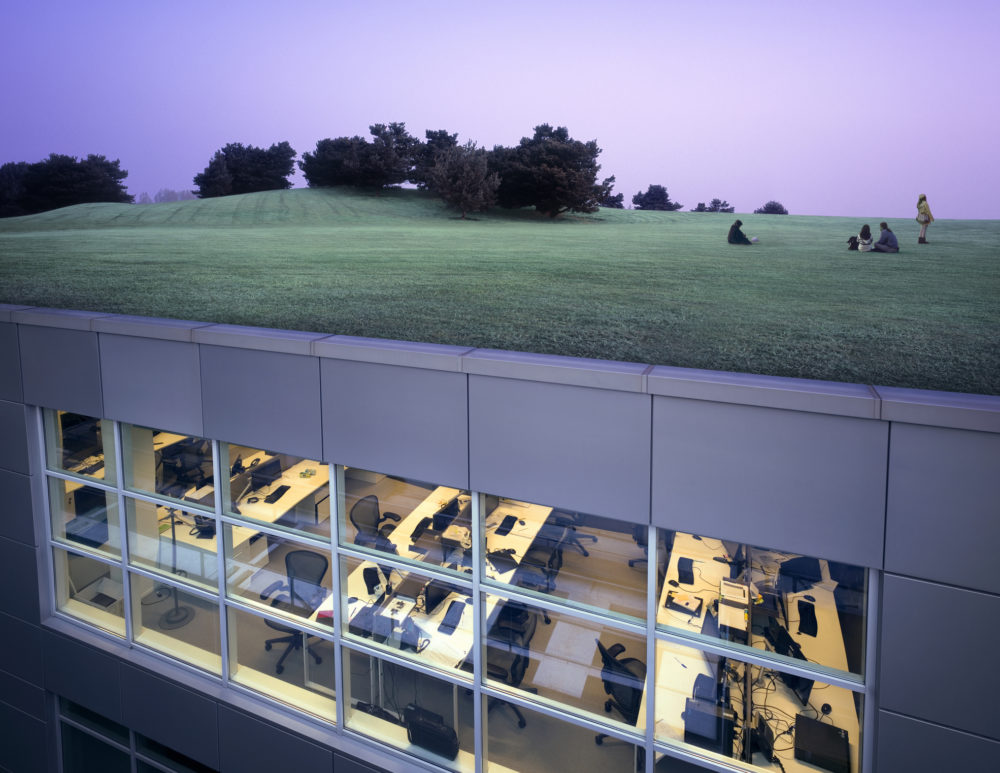 People taking a break in park landscape on top of modern office complex (composite image).