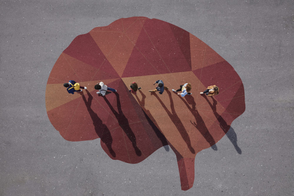 Group of young adults, photographed from above, on various painted tarmac surface, at sunrise.