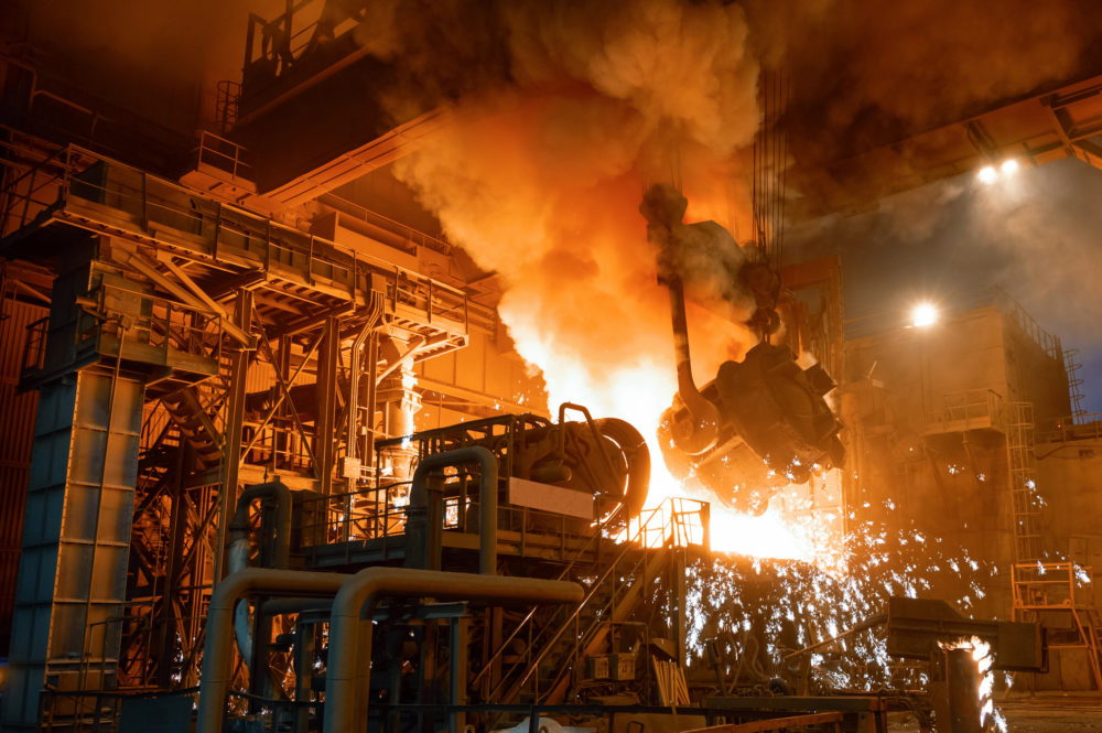 Pouring molten metal into a metallurgical electric arc furnace.